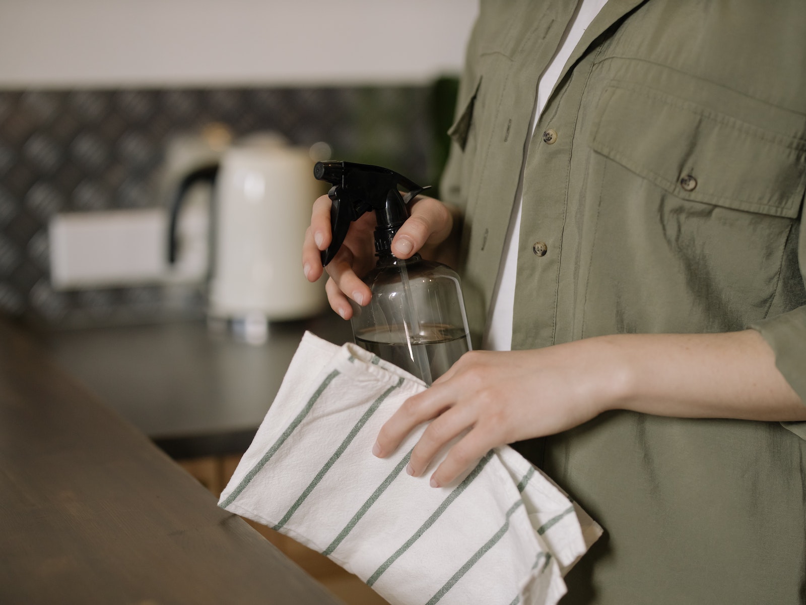 Person in Green Button Up Shirt Holding Clear Drinking Glass